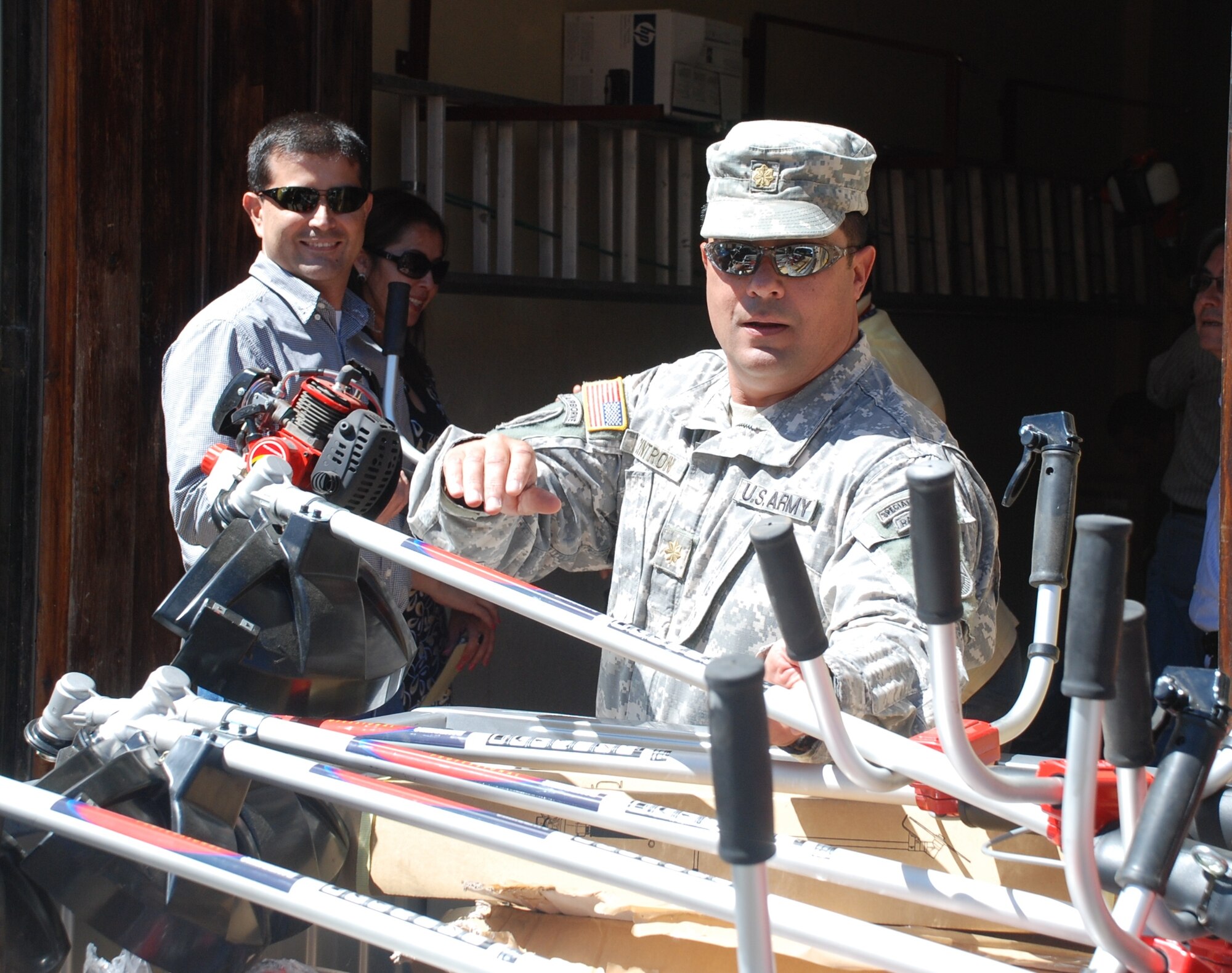 SOTO CANO AIR BASE, Honduras - Maj. Jorge Cintron, Joint Task Force-Bravo Civil - Military Operations director, helps unload a delivery of humanitarian assistance equipment to the city of Comayagua Feb. 28.  JTF-Bravo delivered over nine thousand dollars in equipment to cities surrounding the base to assist in controlling the mosquito population.  JTF-Bravo daily operations demonstrate the professionalism and training of the men and women of Joint Task Force-Bravo and the United States Military and our commitment to the region.  (Air Force photo/Capt. John T. Stamm)