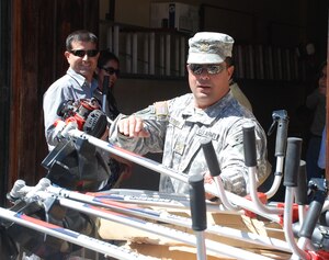 SOTO CANO AIR BASE, Honduras - Maj. Jorge Cintron, Joint Task Force-Bravo Civil - Military Operations director, helps unload a delivery of humanitarian assistance equipment to the city of Comayagua Feb. 28.  JTF-Bravo delivered over nine thousand dollars in equipment to cities surrounding the base to assist in controlling the mosquito population.  JTF-Bravo daily operations demonstrate the professionalism and training of the men and women of Joint Task Force-Bravo and the United States Military and our commitment to the region.  (Air Force photo/Capt. John T. Stamm)