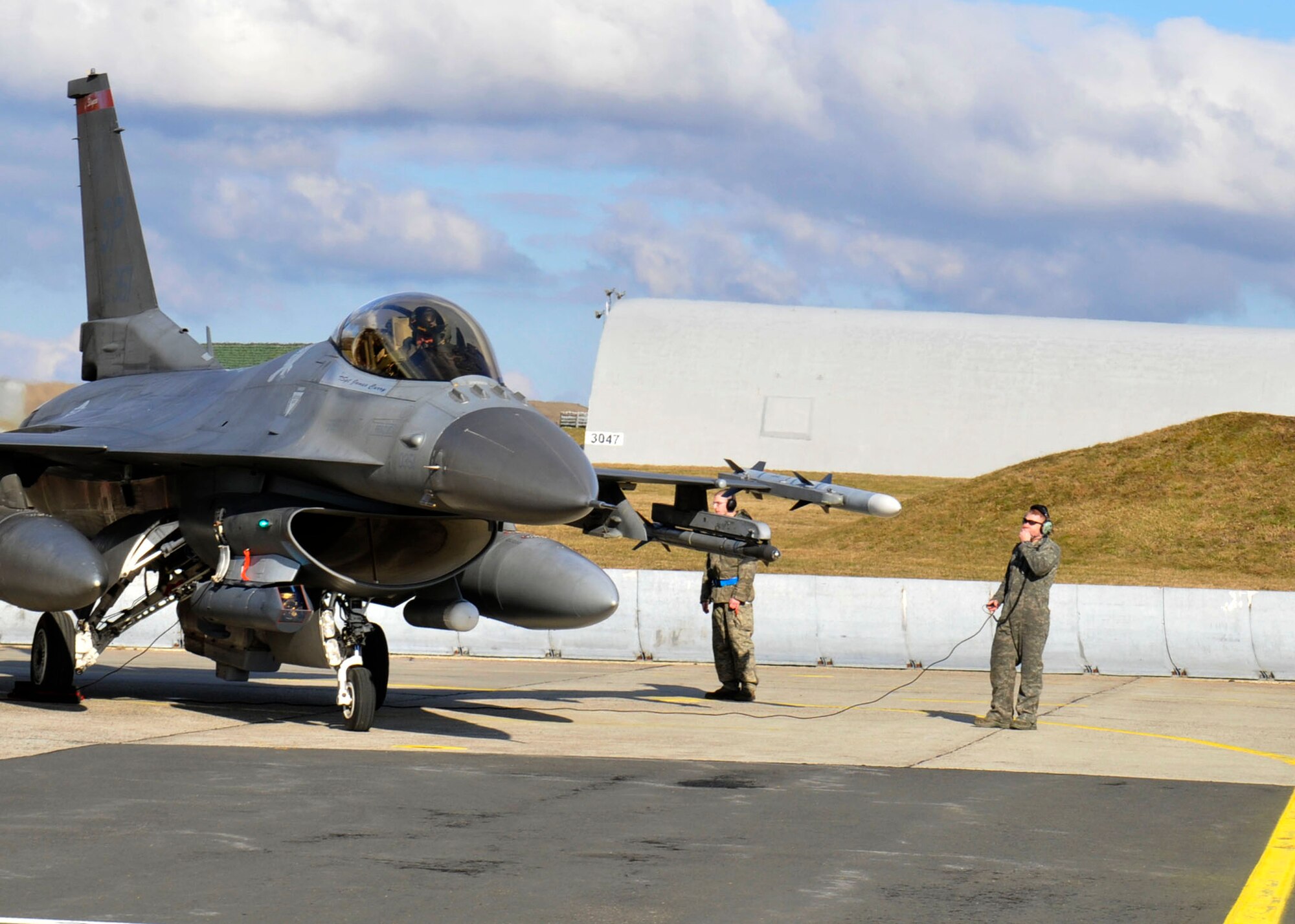 SPANGDAHLEM AIR BASE, Germany—A 480th Fighter Squadron F-16 Fighting Falcon pilot , finishes his post-flight tasks on the flightline here after returning from Nellis Air Force Base, Nev., Feb. 28. The  squadron participated in a seven-week long Red Flag Training Exercise where they accomplished 615 sorties, provided 52 “Saber” incentive flights, dropped 120 heavy weight bombs, fired more than 5,000 rounds of 20 mm ammunition, and flew 27 individual pilot upgrade sorties. (U.S. photo/Airman 1st Class Brittney Frees)