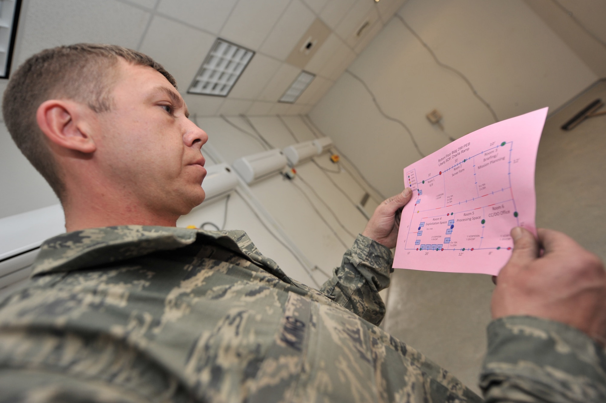 Master Sgt. Russ King, 455th Expeditionary Civil Engineer Squadron electrician, reviews the final drawing to make sure all electrical installation is complete on the new building at Bagram Airfield, Afghanistan, March 3, 2011. Sergeant King is deployed from the 123rd Airlift Wing Air National Guard, Ky. (Air Force photo by Senior Airman Sheila deVera)