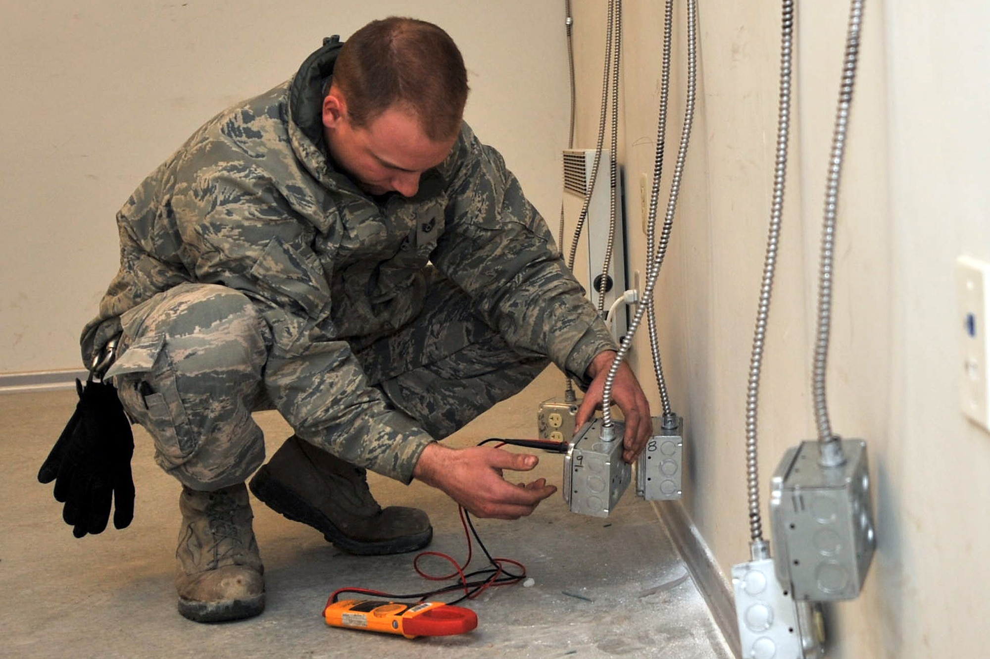 Staff Sgt. Ryan Sendrick, 455th Expeditionary Civil Engineer Squadron electrician, checks the voltage on the electrical receptacle outlet to ensure that it is working properly before installing specialty equipment at Bagram Airfield, Afghanistan, March 3, 2011. (Air Force photo by Senior Airman Sheila deVera)