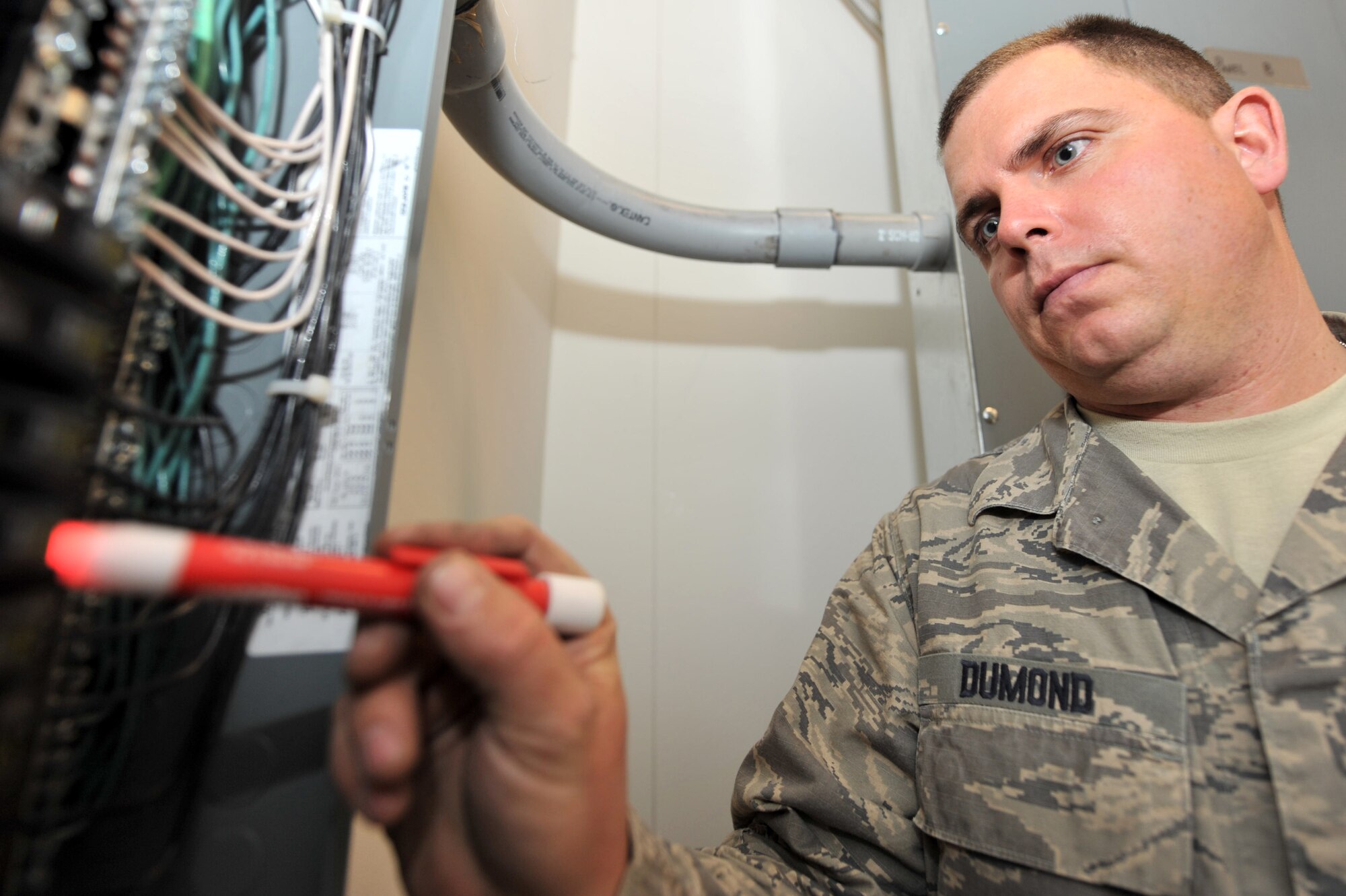Tech. Sgt. Justin Dumond, 455th Expeditionary Civil Engineer Squadron electrician, troubleshoots the circuit for any missing phase due to incoming power, Bagram Airfield, Afghanistan, March 3, 2011. Sergeant Dumond is deployed from the 147th Reconnaissance Wing Air National Guard, Texas. (Air Force photo by Senior Airman Sheila deVera)