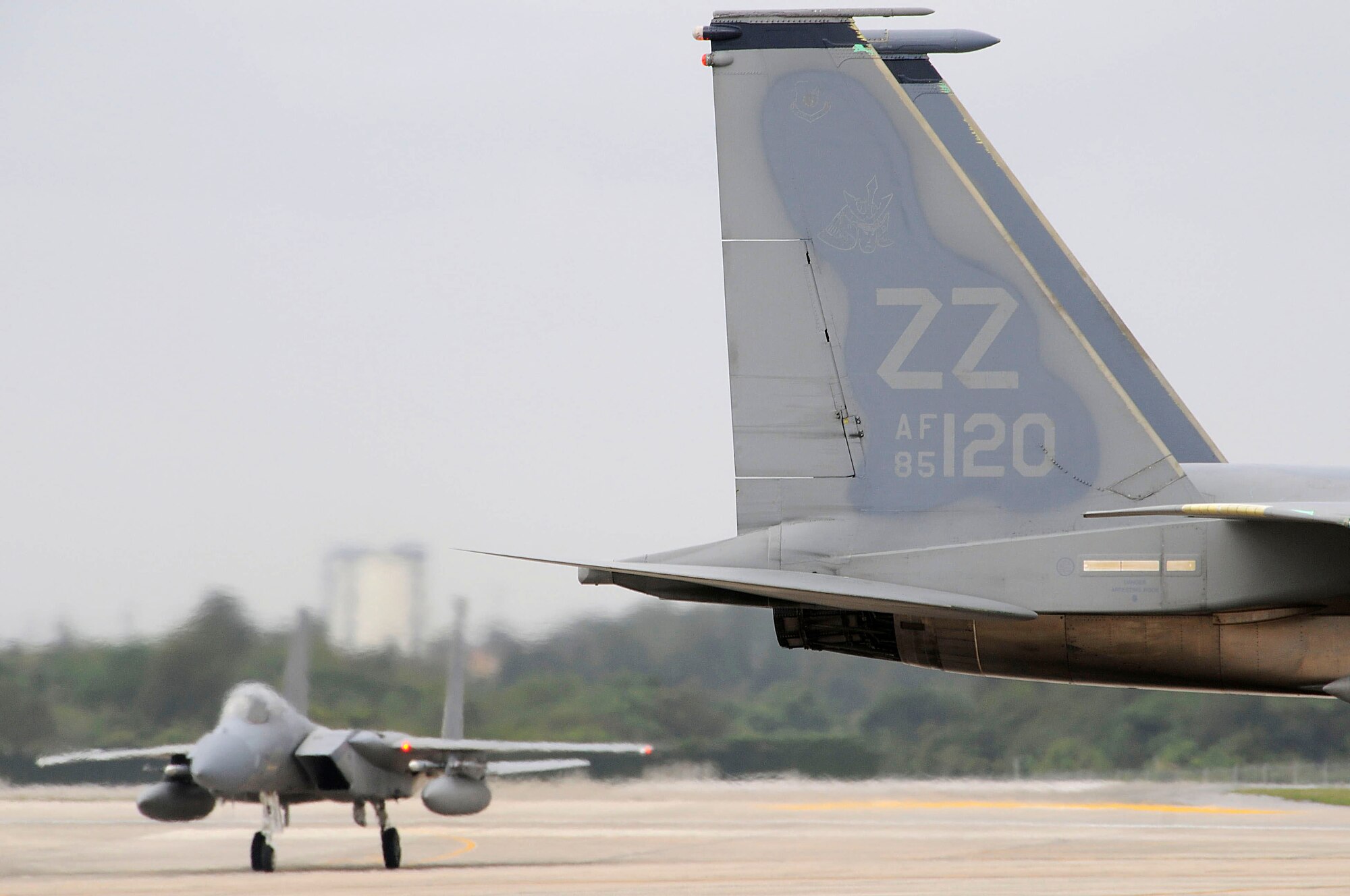 An F-15 Eagle taxis in while others await pre-flight inspection during a local operational readiness exercise at Kadena Air Base, Japan March 2. The exercise tests Team Kadena's ability to operate and complete the mission during various contingency scenarios. (U.S. Air Force photo/ Staff Sgt. Darnell T. Cannady)