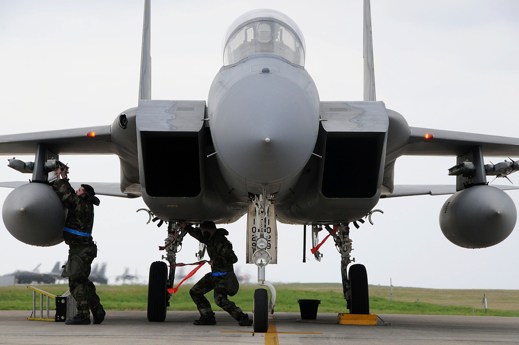 Members from the 18th Aircraft Maintenance Squadron de-arm an F-15 during the local operational readiness exercise at Kadena Air Base, Japan March 2. The exercise tested Team Kadena's ability to operate and complete the mission during various contingency scenarios. (U.S. Air Force photo/ Staff Sgt. Darnell T. Cannady)