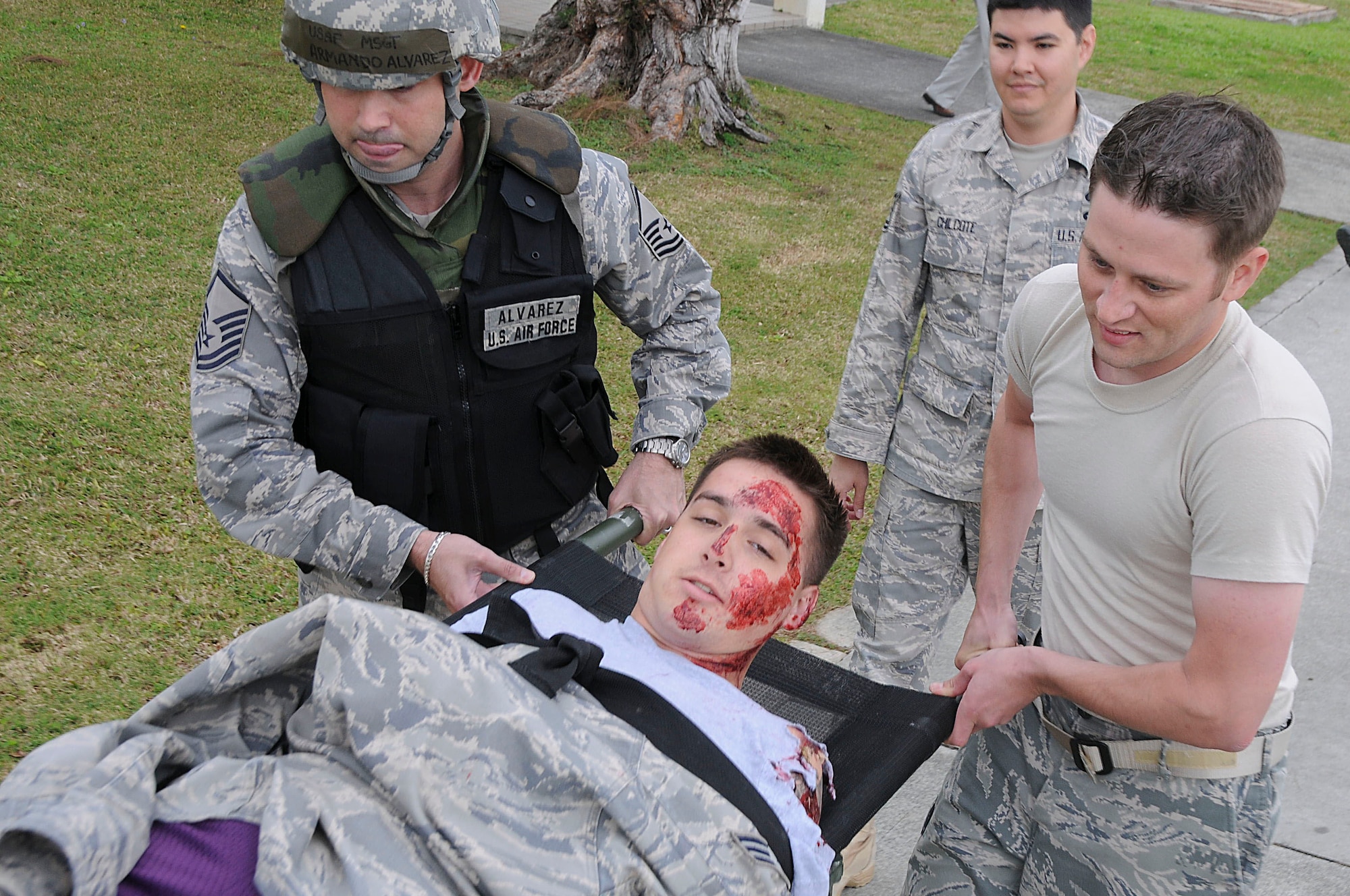 Master Sgt. Armando Alvarez and Staff Sgt. Jacob Bullock, both with the 18th Communications Squadron network control center, carry a simulated victim in a litter during the local operational readiness exercise at Kadena Air Base, Japan March 2. This scenario tested the Airmens’ ability to secure the area and provide self-aid and buddy care after a simulated bomb attack. (U.S. Air Force photo/ Staff Sgt. Darnell T. Cannady)