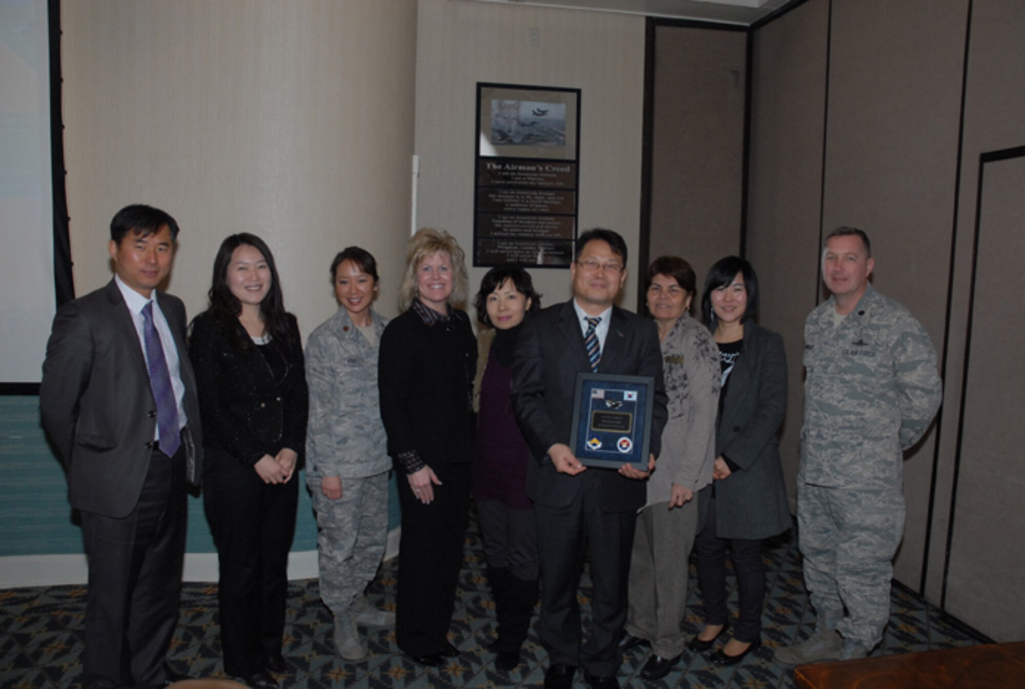 KUNSAN AIR BASE, Republic of Korea -- Jang Young-Jae, Gunsan City Hall international corporation representative, accepts a plaque on behalf of the Gunsan City Good Neighbor Orientation Tour guides who were recently given a tour of Kunsan AB, along with Peggy Baker, wife of Chief Master Sgt. Tom Baker, 7th Air Force command chief. The award was presented by Maj. Angela Kim, 8th Force Support Squadron commander, and Lt. Col. Richard Hubbard, 8th Mission Support Group vice commander. The 8th Fighter Wing’s Airman and Family Readiness Center provided the tour in appreciation to the Gunsan City officials who guide the center’s monthly tour of Gunsan. (Courtesy photo/Yi Song-Chin)