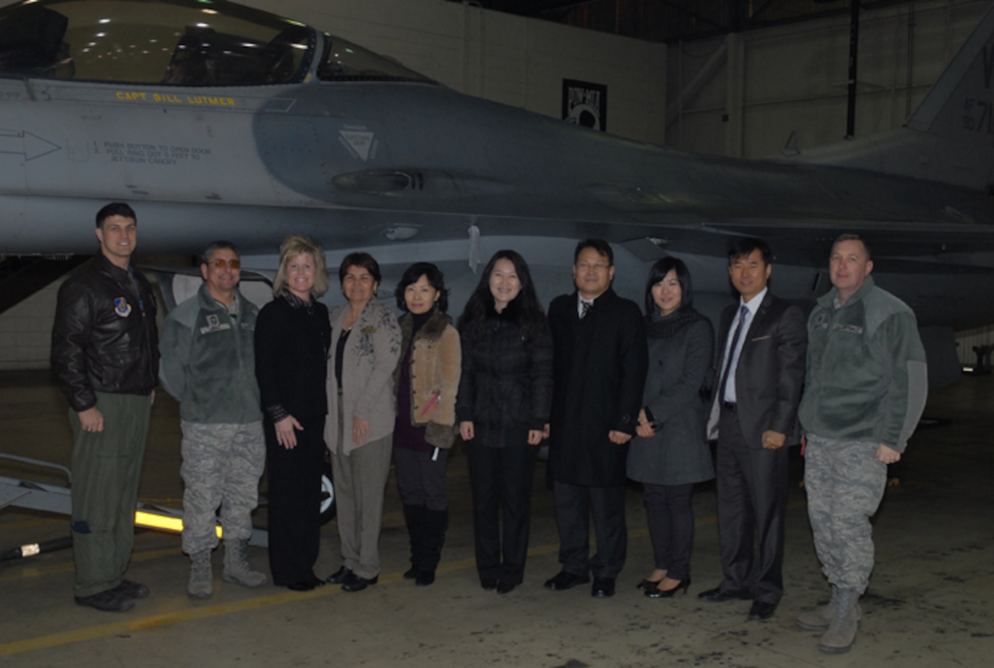 KUNSAN AIR BASE, Republic of Korea -- Participants of a Kunsan AB tour recently provided to Gunsan City Good Neighbor Orientation Tour guides and Peggy Baker, wife of Chief Master Sgt. Tom Baker, 7th Air Force command chief, stop for a picture in front of an F-16 Fighting Falcon static display with Capt. Mason Enright, 35th Fighter Squadron pilot, Chief Master Sgt. Thomas Diaz, 8th Fighter Wing weapons manager, and Lt. Col. Richard Hubbard, 8th Mission Support Group vice commander. The 8th Fighter Wing’s Airman and Family Readiness Center provided the tour in appreciation to the Gunsan City officials who guide the center’s monthly tour of Gunsan. (Courtesy photo/Yi Song-Chin)