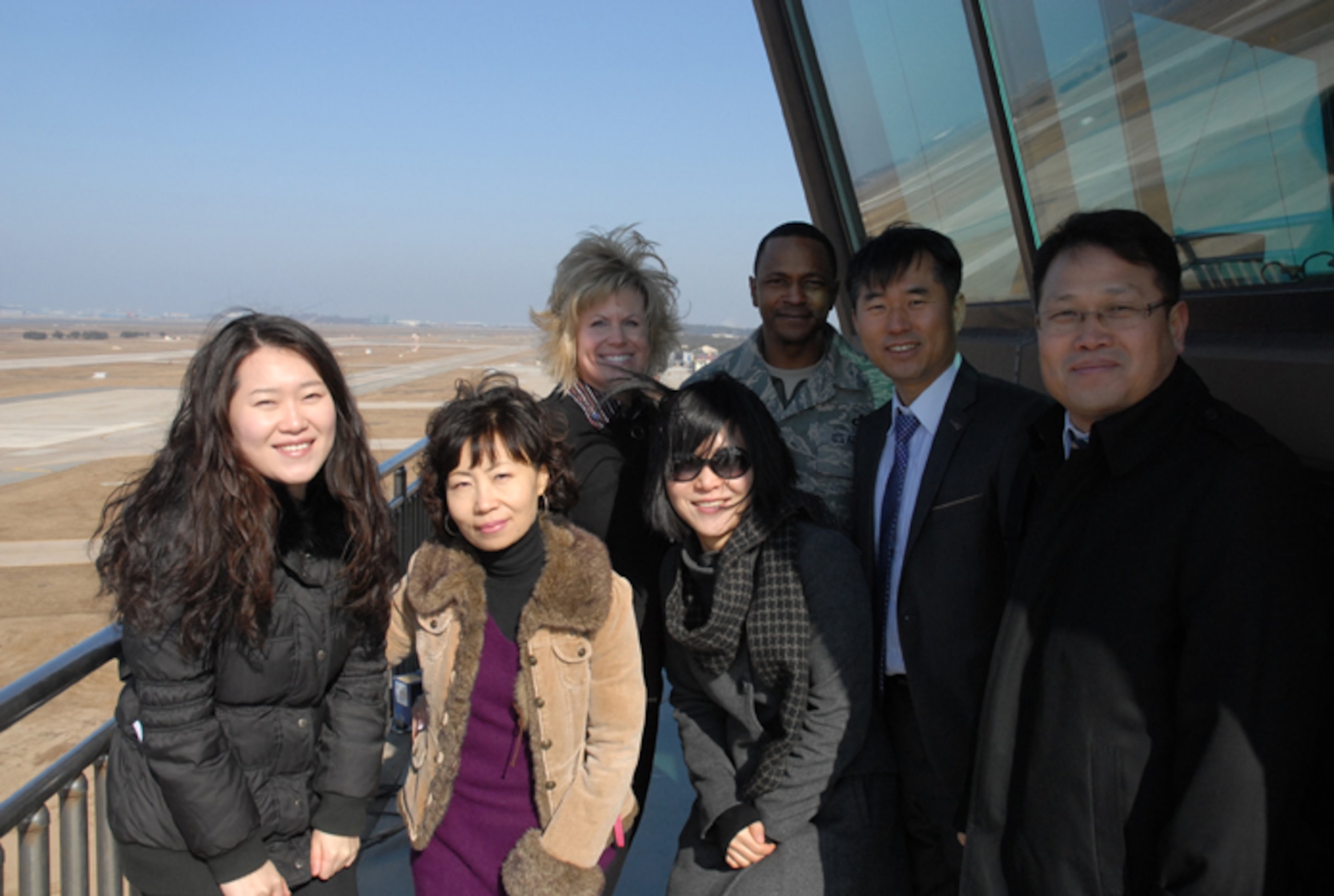 KUNSAN AIR BASE, Republic of Korea -- Participants of a Kunsan AB tour recently provided to Gunsan City Good Neighbor Orientation Tour guides and Peggy Baker, wife of Chief Master Sgt. Tom Baker, 7th Air Force command chief, take a tower visit with Senior Master Sgt. Michael Murdock, 8th Operations Support Squadron control tower chief controller. The 8th Fighter Wing’s Airman and Family Readiness Center provided the tour in appreciation to the Gunsan City officials who guide the center’s monthly tour of Gunsan. (Courtesy photo/Yi Song-Chin)