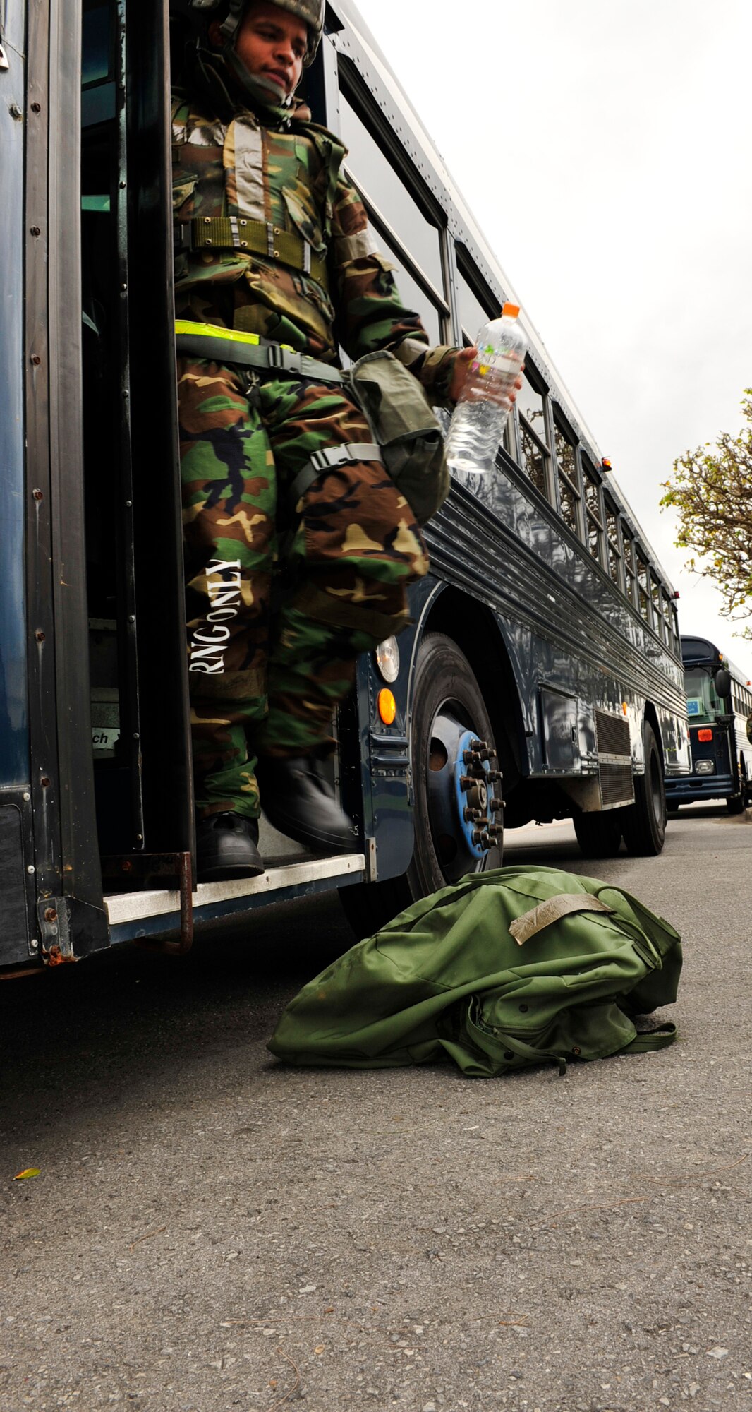 Airman 1st Class Steven Bradford, a vehicle operator with the 18th Logistics Readiness Squadron, departs from a shuttle bus to begin his shift during the local operation readiness exercise here at Kadena Air Base, Mar. 2. The LORE is a way to prepare base personnel for real world contingencies and practice operations in different exercise scenarios. (U.S Air Force photo/ Staff Sgt. Lakisha A. Croley) 