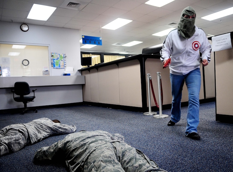 An Airman from the 36th Security Forces Squadron, acting as a robbery suspect, flees the scene of the crime at the 36th Comptroller Squadron March 1, as part of an Operational Readiness Exercise. The ORE scenario evaluated security forces personnel’s response in the event of an armed robbery. (U.S. Air Force photo/Airman 1st Class Jeffrey Schultze)