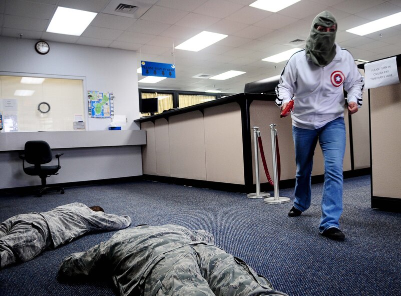 An Airman from the 36th Security Forces Squadron, acting as a robbery suspect, flees the scene of the crime at the 36th Comptroller Squadron March 1, as part of an Operational Readiness Exercise. The ORE scenario evaluated security forces personnel’s response in the event of an armed robbery. (U.S. Air Force photo/Airman 1st Class Jeffrey Schultze)