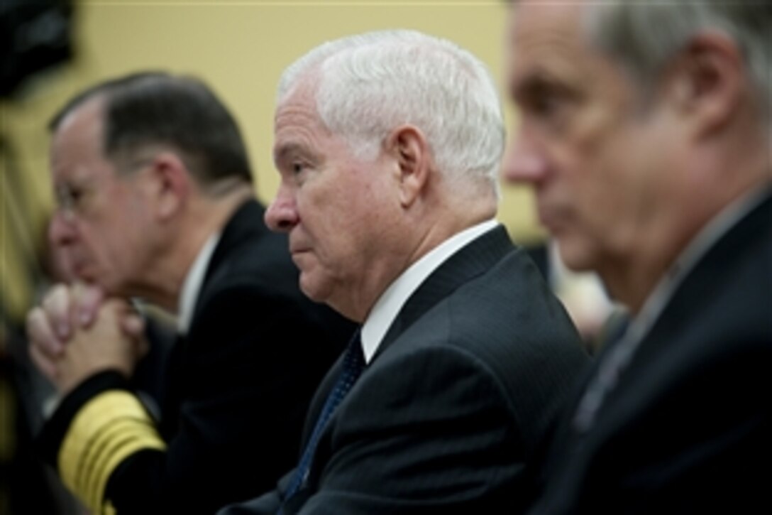 Chairman of the Joint Chiefs of Staff Adm. Mike Mullen, left, Defense Secretary Robert M. Gates, center, and Undersecretary of Defense (Comptroller) Robert F. Hale testify at a hearing of the House Appropriations Committee's defense subcommittee on the fiscal 2012 budget in Washington, D.C., March 3, 2011. 