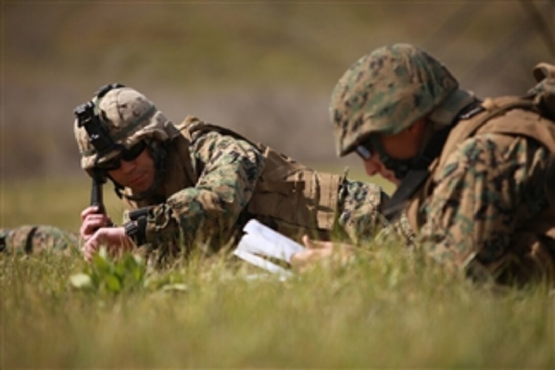 Capt. Christopher Robb, the forward air controller, with 1st Tank Battalion quick reaction force, calls in their position to their higher headquarters after securing a landing zone during a tactical air raid as part of Exercise Iron Fist on Feb. 28, 2011.  Iron Fist is a bilateral training event focused on improving U.S./Japanese interoperability.  
