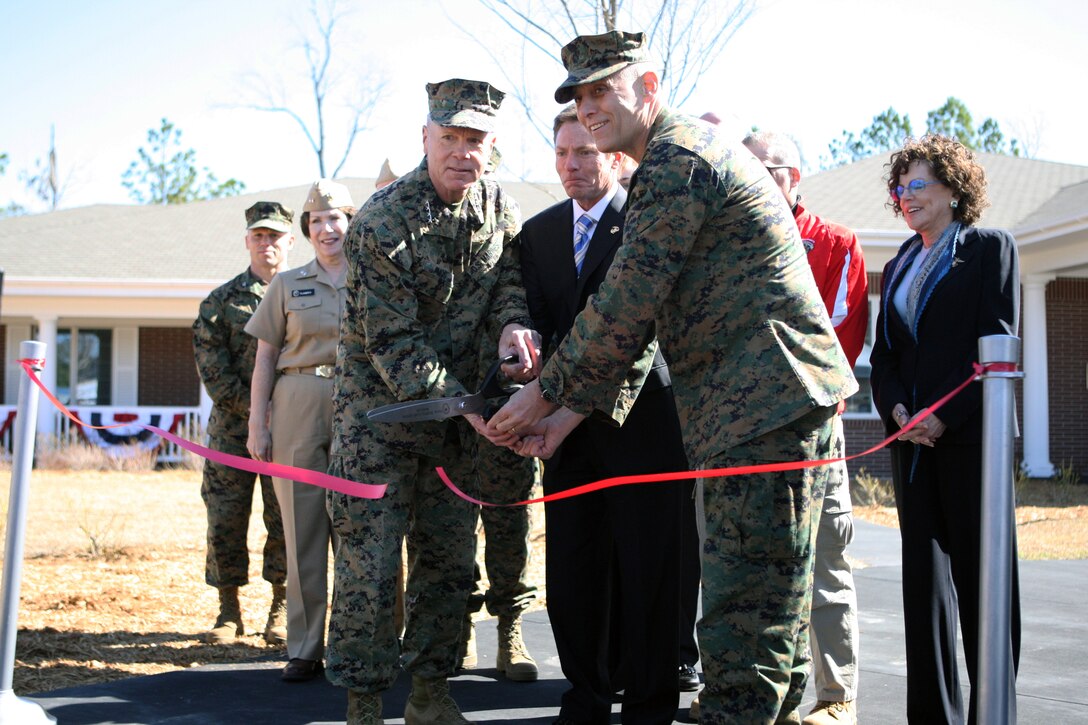 (From left, front) Gen. James Amos, commandant of the Marine Corps; Kenneth Fisher, CEO of the Fisher House Foundation and Lt. Gen. John M. Paxton, commanding general of the II Marine Expeditionary Force, cut the ribbon marking the opening of the Fisher House aboard Marine Corps Base Camp Lejeune, March 3.