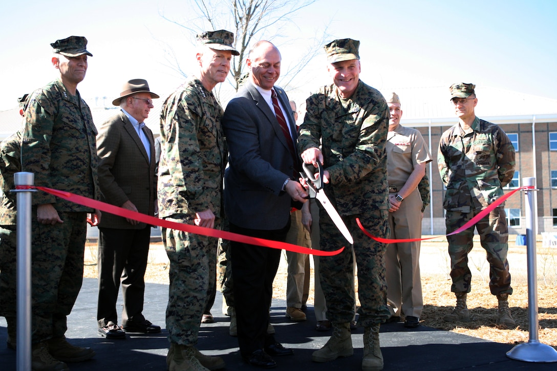 (From left, front) Gen. James Amos, commandant of the Marine Corps; retired Maj. Gen. Robert Dickerson, former commanding general of Marine Corps Installations East, and Maj. Gen. Carl Jensen, commanding general of MCIEast, cut the ribbon marking the opening of the Wounded Warrior Battalion – East Bachelor Enlisted Quarters aboard Marine Corps Base Camp Lejeune, March 3.