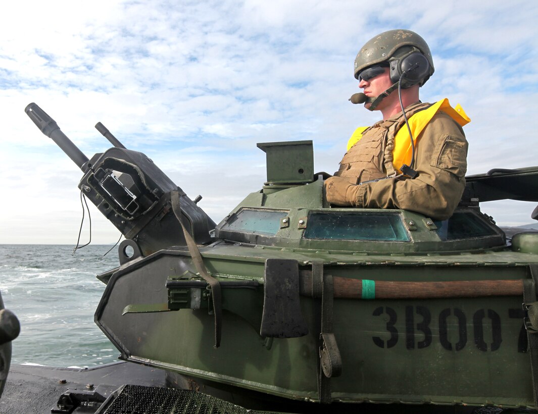 Cpl. Seth A. Shull, a crew chief with 1st platoon, Bravo Company, 3rd Assault Amphibian Battalion, keeps a clear view of his destination, the USS Dubuque (LPD 8), from the turret of an amphibious assault vehicle off Camp Pendleton's coast, March 2. Shull's company is participating in Pacific Horizon 11, a maritime prepositioning force exercise to prepare Marines and sailors for crisis response. (U.S. Marine Corps Photo by Sgt. Marcy Sanchez)