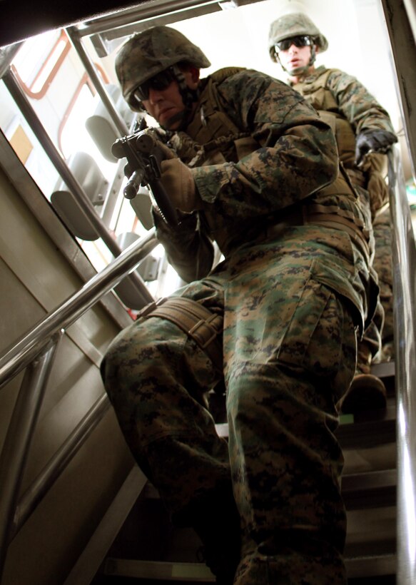 During a Visit, Boarding, Search and Seizure course, Lance Cpl. James A. Scarborough, a native of Montevallo, Ala., attached to Black Sea Rotational Force-11, rushes down the steps of the U.S. Coast Guard Cutter Sea Otter, U.S. Coast Guard Sector San Diego, San Diego, Calif., to secure the ship in a training exercise in Oceanside, Calif. The Marines were selected from the Ground Combat Element to undergo training and work with the Coast Guard to learn new skills that will help them on their deployment to the Black Sea, Balkan and Caucasus regions.