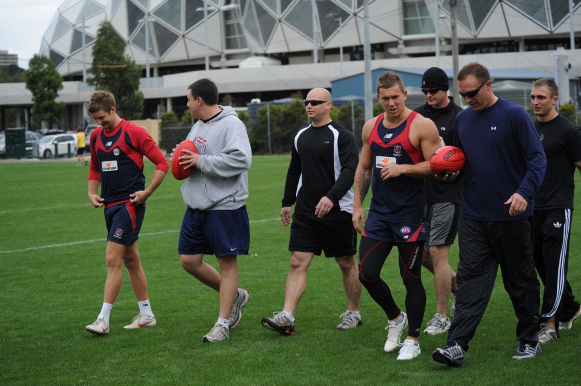 Airmen joined Sailors in gaining some knowledge about Australian Rules Football from players representing the Melboune Demons Football Club at Gosch’s Paddock in Melbourne, Australia, March 4, 2011. The Airmen are from Kadena Air Base, Japan, and Dyess Air Force Base, Texas, while the Sailors are from the  San Diego-based USS Shoup. The two groups took time out from attending the Avalon 2011 Australian International Airshow and Aerospace and Defence Exposition in Geelong, Australia. The event is one of the largest airshows in the world. The U.S. and Australian alliance spans more than 60 years and provides an opportunity for U.S and senior military officials to engage with their Australian counterparts, and ultimately contribute toward interoperability between the forces. (U.S.  Air Force photo/Master Sgt. Cohen A. Young)