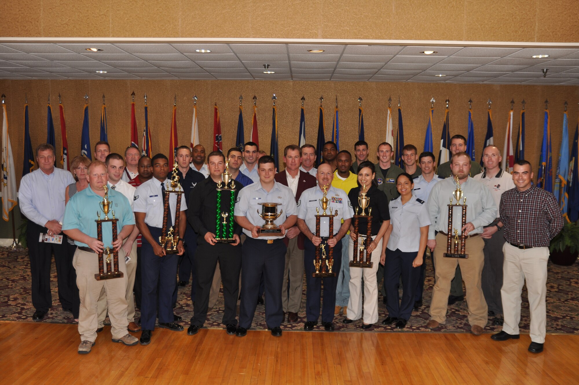 Team BLAZE members recognized during the third Annual Awards Banquet hold their trophies high alongside the guest speaker and Team BLAZE leadership for the event at the Columbus Club on Feb. 28. (U.S. Air Force photo/Airman 1st Class Chase Hedrick)