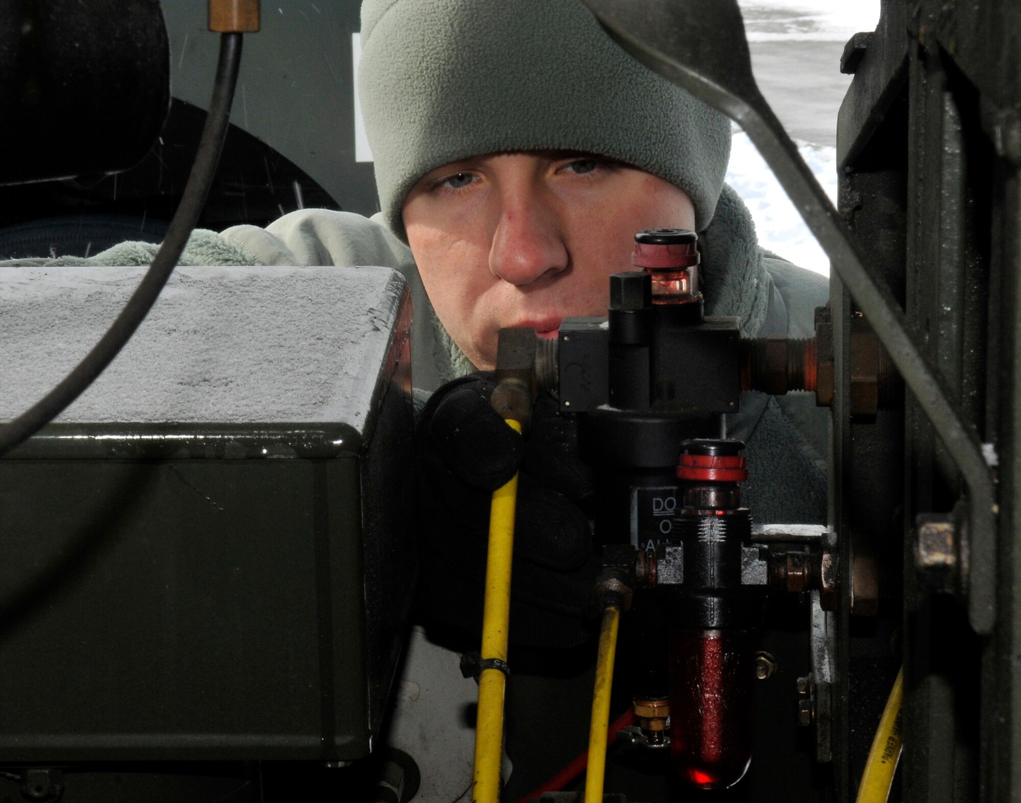 U.S. Air Force Senior Airman Joseph Kerr, 35th Logistics Readiness Squadron fuels technician, inspects a pneumatic line on an R-11 fuel truck's hose-realer system Mar. 3, 2011, Misawa Air Base, Japan. Fuels technicians can fuel or defuel any U.S. military aircraft. (U.S. Air Force photo by Tech. Sgt. Phillip Butterfield/Released)