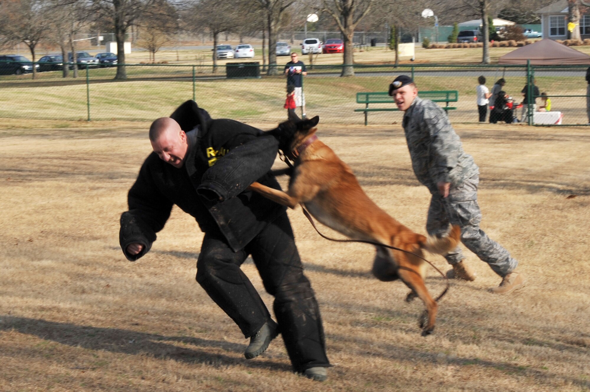 Staff Sgt. Beau Hansen, a 19th Security Forces Squadron dog handler, is subdued by 19th SFS working dog Bartje as Bartje’s handler, Staff Sgt. David Wyatt, gives verbal commands during a working dog demonstration March 3, 2011, at Little Rock Air Force Base, Ark. The demonstration was part of Uran Memorial Dog Park grand opening day activities. The park is dedicated and named for fallen 19th Security Forces Squadron Military Working Dog Uran, a veteran of five deployments in support of Operations Iraqi Freedom and Enduring Freedom. (U.S. Air Force photo by Airman 1st Class Rusty Frank)