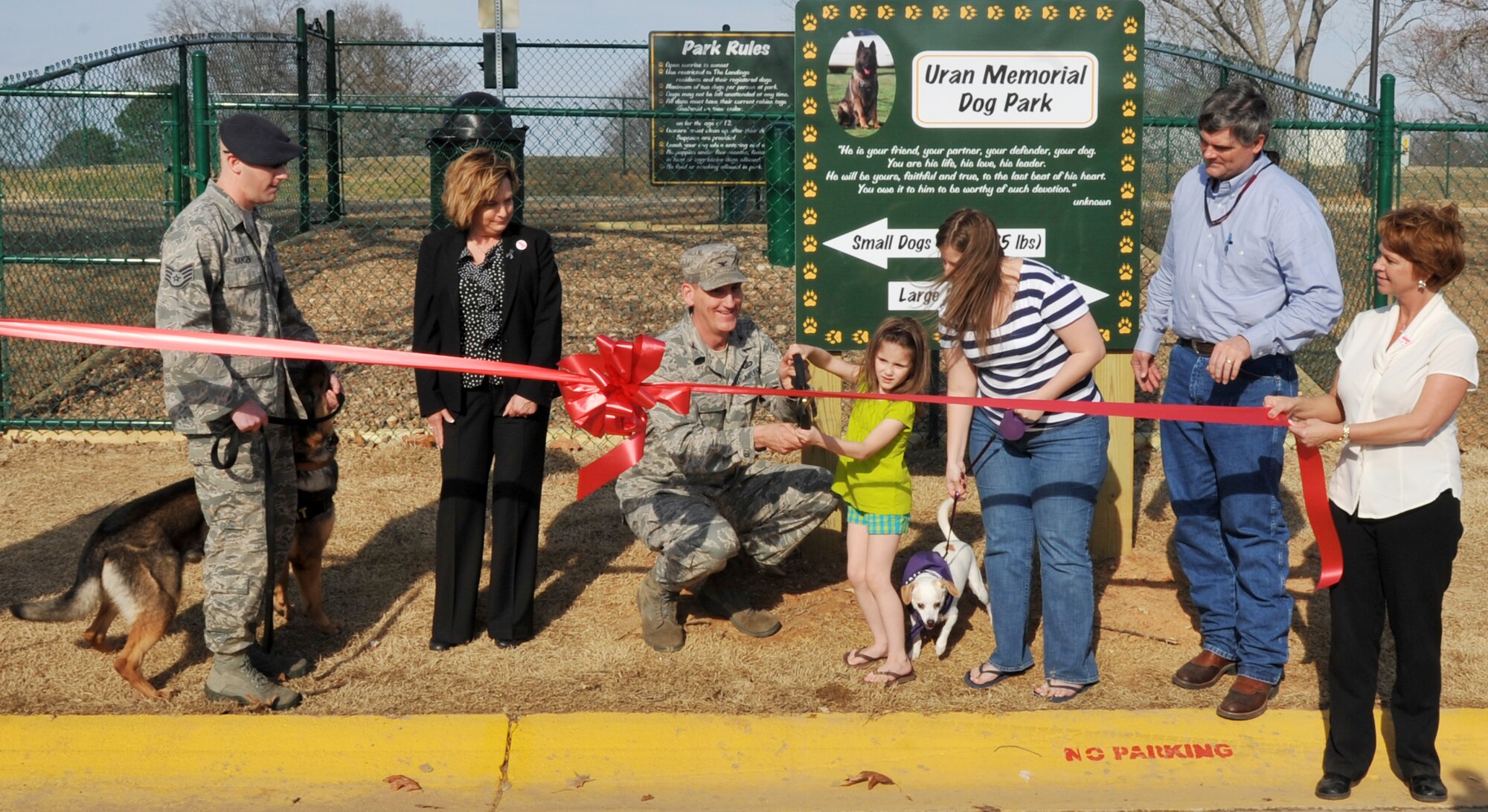 (From left) Staff Sgt. Beau Hansen, a 19th Security Forces Squadron dog handler; Joanne Carlon, a 19th Civil Engineer Squadron asset manager; Col.  George Coggins, 19th Mission Support Group commander;  Madison Lendenmann (5) and her mother, Amanda Lendenmann; Russell McSpeden, Hunt project manager; and Suzan Inskeep, wife of Chief Master Sgt. Kevin Inskeep, 19th Maintenance Group, cut the ribbon at Uran Memorial Dog Park at Little Rock Air Force Base, Ark., March 3, 2011. The park is dedicated and named for fallen 19th Security Forces Squadron Military Working Dog Uran, a veteran of five deployments in support of Operations Iraqi Freedom and Enduring Freedom. (U.S. Air Force photo by Airman 1st Class Rusty Frank)