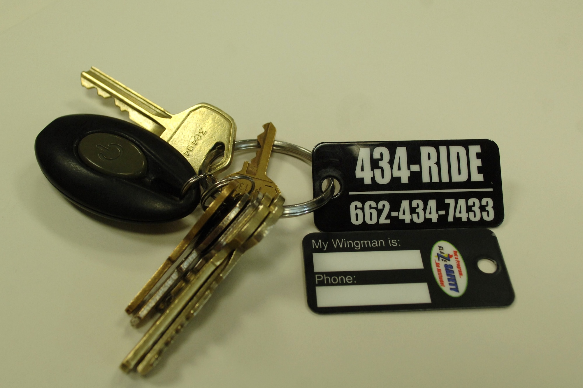 Official 434-RIDE program key chain tags were passed out to base members Feb. 25 at the Kaye Auditorium. Tags provide a location to record your Wingman’s name and phone number and serve as a visible reminder to call someone when you shouldn’t drive. (U.S. Air Force Photo/ Staff Sgt. Bryan Franks)