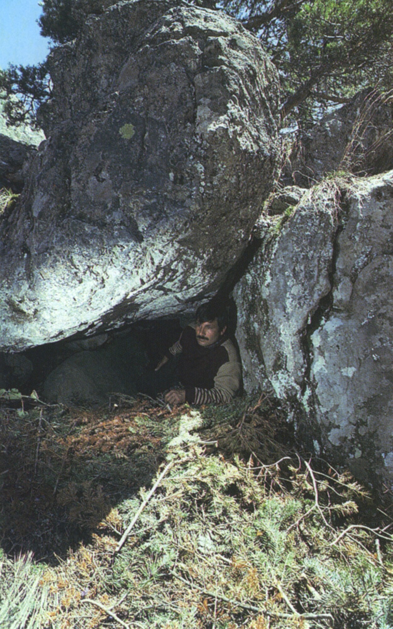 MIRACLE ON THE MOUNTAIN - A Turkish lumberjack, Isa Celik, demonstrates how cramped the quarters were for Mike and Matt Couillard in the small cave. Throughout the night, each dozed in about half-hour spurts before being rudely interrupted by the icy fingers of Mother Nature or by a sudden movement from the other, hopelessly jockeying for a more comfortable position. (Photo by Rose Reynolds)
