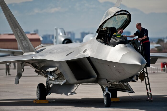 NELLIS AIR FORCE BASE, Nev. --  Airman 1st Class Jonathan Foster, 49th Aircraft Maintenance Squadron, crew chief, from Holloman Air Force Base, N.M. shakes hands with Maj. Daniel Lehoski, 8th Fighter Squadron, pilot  before he departs in an F-22 Raptor for a training mission during Red Flag 11-3, March 2.  Red Flag is a realistic combat training exercise involving the air forces of the United States and its allies. The exercise takes place north of Las Vegas on the Nevada Test and Training Range--the U.S. Air Force's premier military training area with more than 12,000 square miles of airspace and 2.9 million acres of land. (U.S. Air Force photo by Tech Sgt. Michael R. Holzworth)
