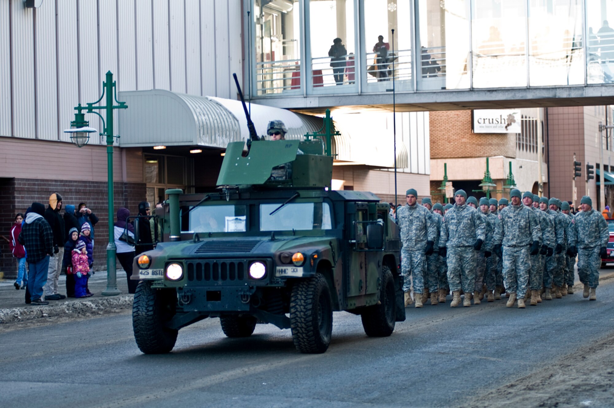 Soldiers from B Company, 425th Brigade Special Troops Battalion, 4th Brigade Combat Team (Airborne), 25th Infantry Division, march behind an up-armored humvee, Feb. 26, during the Anchorage Fur Rendezvous Festival parade. (U.S. Air Force photo/Percy Jones)