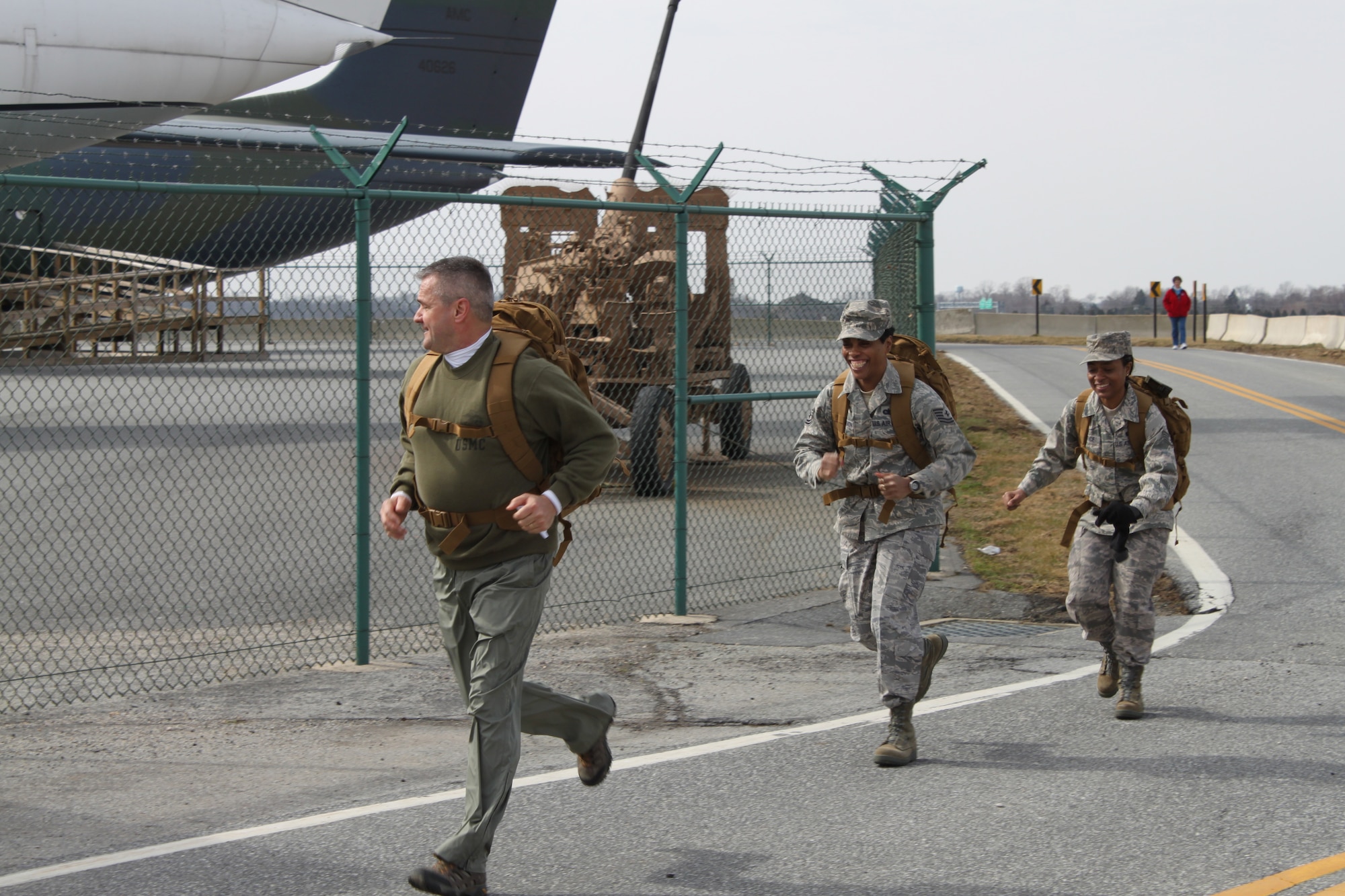 William Zwicharowski, Air Force Mortuary Affairs Operations, Tech. Sgt. Gail Reed-Harmon and Staff Sgt. Mable Justice, both with 512th Memorial Affairs Squadron, take the last corner on their way to the finish line during the 12th Annual Chosin Reservoir Commemorative Ruck March Feb. 26, 2011. More than 40 teams participated in the Ruck March. (U.S. Air Force photo by Christin Michaud/Released)
