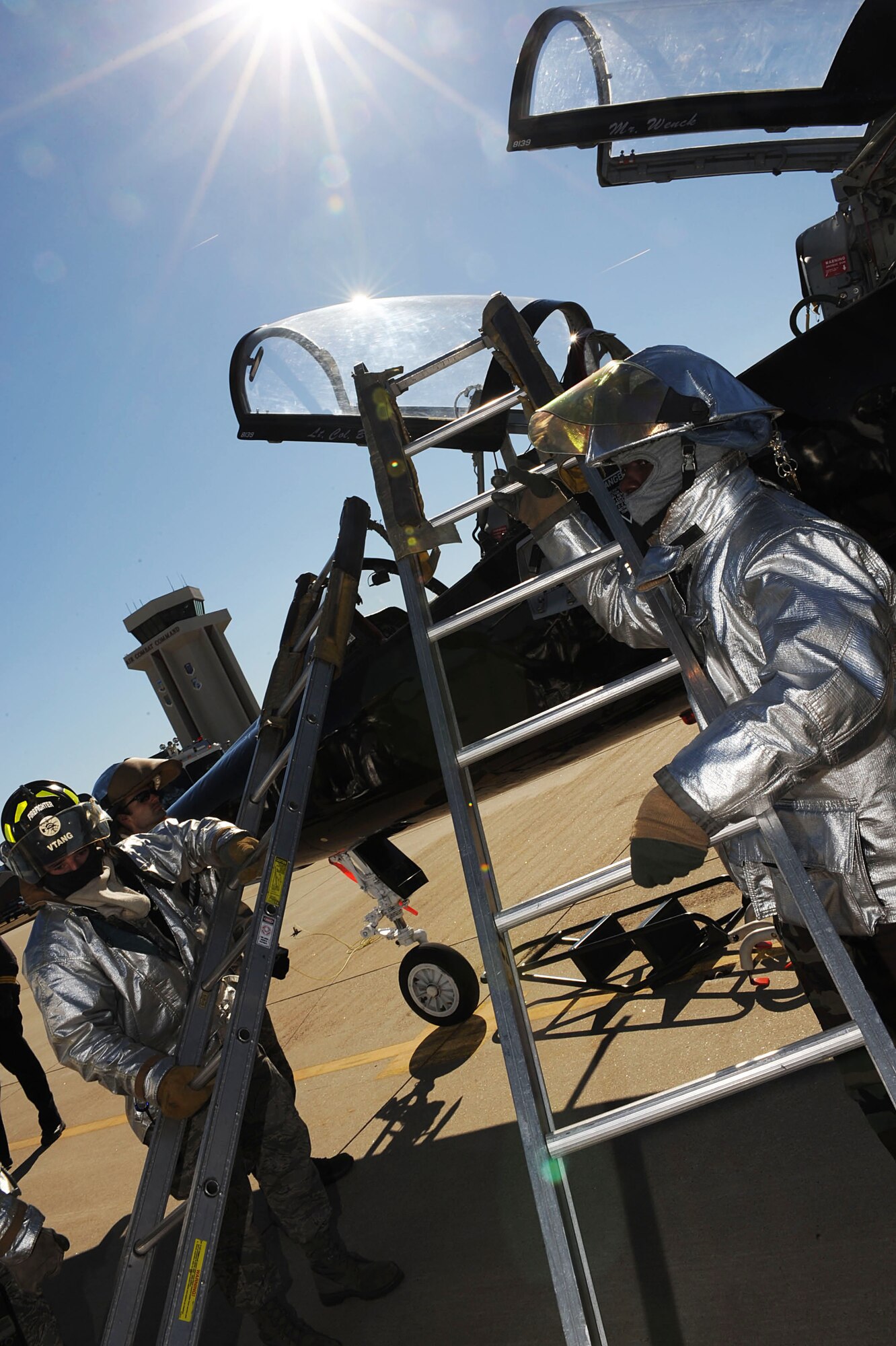 Staff Sgt. Brannon Soter, 158th Civil Engineer Squadron firefighter, and SSgt Hendrix Fuller, crew Chief, 633 CES remove latters from a T-38 Talon at Langley Air Force Base, Va., March 3, 2011. The Langley Fire Department is participating in extraction training to ensure firefighters can adequately remove a pilot during an emergency. (U.S. Air Force photo by Senior Airman Brian Ybarbo/Released)
