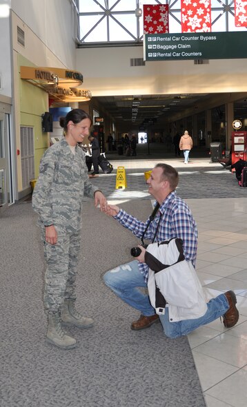 WRIGHT-PATTERSON AIR FORCE BASE, Ohio - Tech. Sgt. Leslie Lovegrove, 87th Aerial Port Squadron, was greeted by family and friends at the Dayton International Airport Feb. 11 after returning from a four-month deployment to Joint Base Balad.  After her arrival at the airport, her boyfriend, Master Sgt. Scott Schrier, 445th Mission Support Group, client support administrator, got down on one knee and proposed. She accepted his proposal. The wedding is scheduled for June 2012. (U.S. Air Force photo/Lt. Col. Cynthia Harris) 