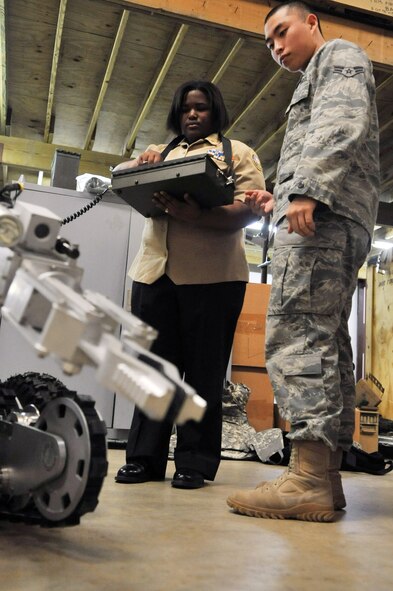 A Member from the 2nd Civil Engineer Squadron Explosive Ordnance Disposal Flight teaches a Navy Junior Reserve Officer Training Corps cadet from Neville High School how to operate an Andros F6A EOD robot in the EOD garage on Barksdale Air Force Base, La., March 2. During their visit, the cadets were able to don an explosive ordnance disposal suit and examine examples of improvised explosive devices and unexploded ordnance. Neville High School is located in Monroe, La. (U.S. Air Force photo/Airman 1st Class Micaiah Anthony)(RELEASED)