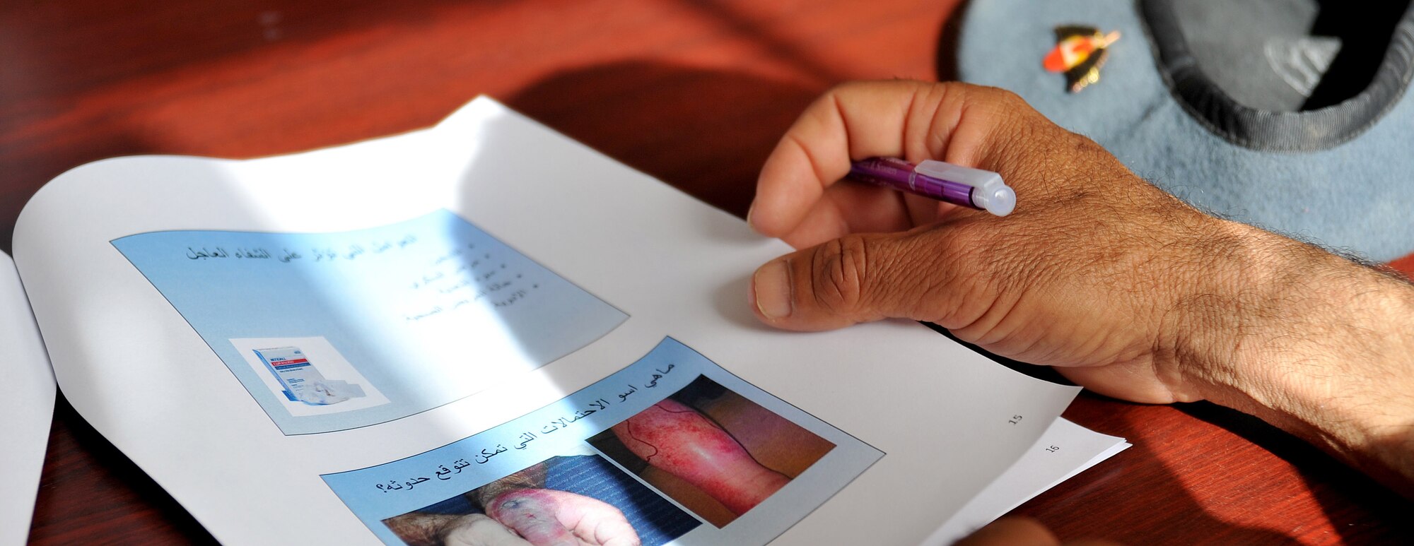 An Iraqi airman reads a booklet on various types of injuries during a medical training course Feb. 23, 2011, at the medical clinic on Ali Air Base, Iraq. Airmen assigned to the base transition team here have helped improve the clinic’s ability to meet the needs of the Iraqi Air Force by providing $200,000 in essential medical equipment, increasing storage capacity and coordinating monthly self-aid buddy care training. (U.S. Air Force photo by Senior Airman Andrew Lee/Released)