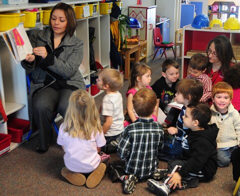 Jackie Turner, wife of Staff Sgt. Daniel Turner, Air Force Financial Services Center military pay technician, reads "The Foot Book" by Dr. Seuss, to children at the Child Development Center, March 3, 2011.  Mrs. Turner reads to the children as part of the Read Across America, a national program, honoring the birthday of Dr. Seuss by reading his books to children. (U.S. Air Force photo/Senior Airman Anthony Sanchelli)
