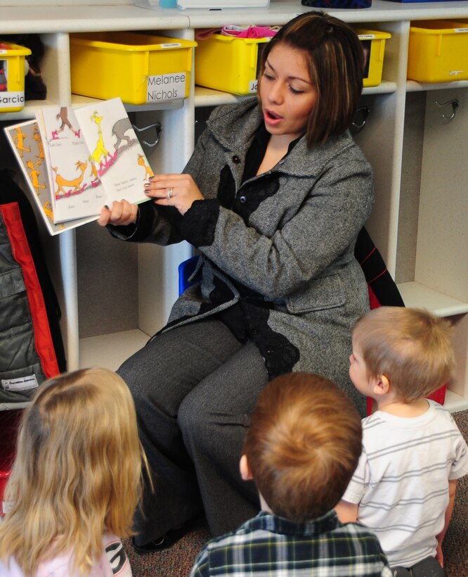 Jackie Turner, wife of Staff Sgt. Daniel Turner, Air Force Financial Services Center military pay technician, reads "The Foot Book" by Dr. Seuss, to children at the Child Development Center, March 3, 2011.  Mrs. Turner reads to the children as part of the Read Across America, a national program, honoring the birthday of Dr. Seuss by reading his books to children. (U.S. Air Force photo/Senior Airman Anthony Sanchelli)
