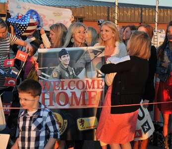 Families of deployed Airmen from the 16th Airlift Squadron await the arrival of their loved ones March 3. The 16 AS returned home from a 120 day deployment in the Middle East. (U.S. Photo/ Airman 1st Class Jared Trimarchi)