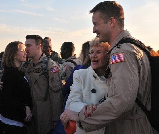Capt. ZacharyCoburn (left) and Capt. Clark Grosvenor, pilots from the 16th AirliftSquadron, are greeted by their families March 3, after returning from adeployment to the Middle East. More than 130 Airmen from the 16 AS returnedhome from their 120-day deployment.