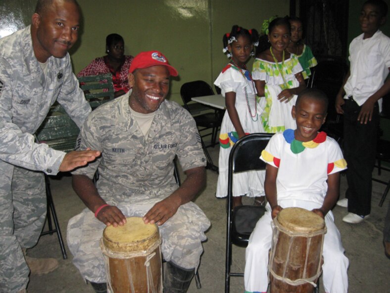 Staff Sgt Kevin Keith, (middle) a heavy equipment journeyman with the 567th RED HORSE, along with Master Sgt. Bennie Baker, security forces, plays the drums with local Meteti children while on deployment for New Horizons 2010. Panamanians performed locally influenced shows before U.S. military departures.(USAF photo courtesy of the 567RHS)