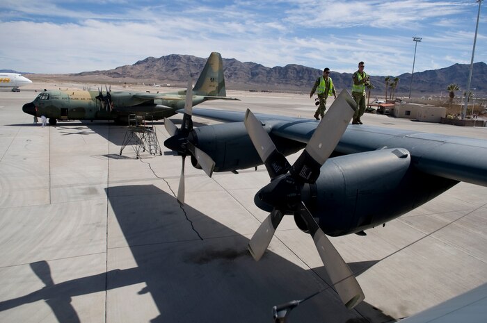 NELLIS AIR FORCE BASE, Nev. -- Royal Australian Air Force aircraft mechanics walk along the wing of a C-130H Hercules during Red Flag 11-3 March 1. Red Flag is a realistic combat training exercise involving the air forces of the United States and its allies. The exercise takes place north of Las Vegas on the Nevada Test and Training Range--the U.S. Air Force's premier military training area with more than 12,000 square miles of airspace and 2.9 million acres of land. (U.S. Air Force photo by Airman 1st Class George Goslin)