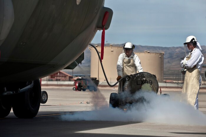 NELLIS AIR FORCE BASE, Nev. -- Royal Australian Air Force Leading Air Craftsmen aircraft mechanics Grant Flormio and Rhys Utley, from No. 37 Squadron Richmond, Australia perform liquid oxygen replenishment on a C-130H Hercules during Red Flag 11-3, March 1.  Red Flag is a realistic combat training exercise involving the air forces of the United States and its allies. The exercise takes place north of Las Vegas on the Nevada Test and Training Range--the U.S. Air Force's premier military training area with more than 12,000 square miles of airspace and 2.9 million acres of land. (U.S. Air Force photo by Tech Sgt. Michael R. Holzworth)