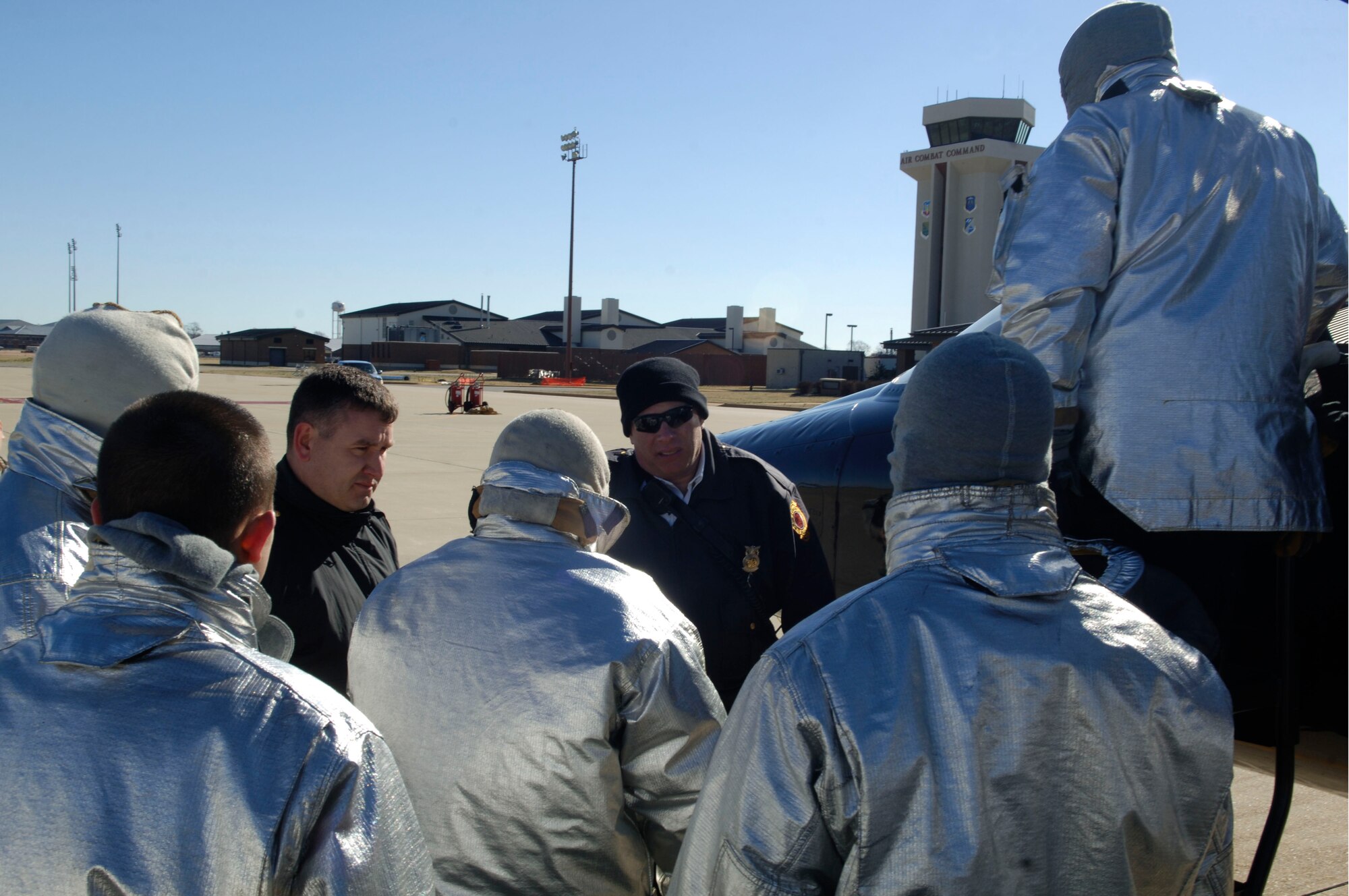Douglas Faber, 633rd Civil Engineer Squadron Fire Department assistant chief of training, briefs firefighters about the proper T-38 Talon extraction training procedures at Langley Air Force Base, Va., March 3, 2011. Firefighters perform hands-on training in order to prepare for the arrival of the new aircraft at Langley. (U.S. Air Force photo by Airman 1st Class Racheal Watson/Released)