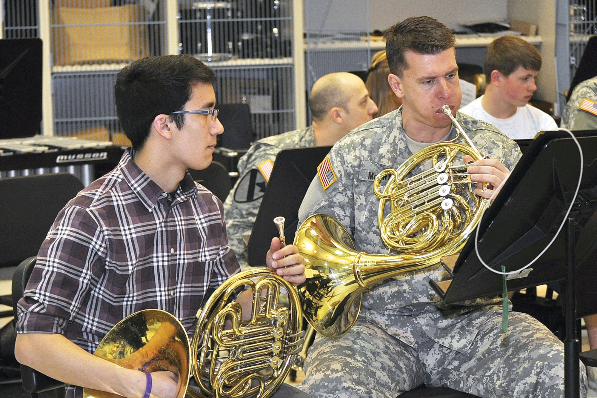 Army Staff Sgt. James McSwain, 9th Army Band, plays the French horn with students
during a music clinic at East High School, Feb. 25. (U.S. Army photo/Sgt. Tamika Dillard)