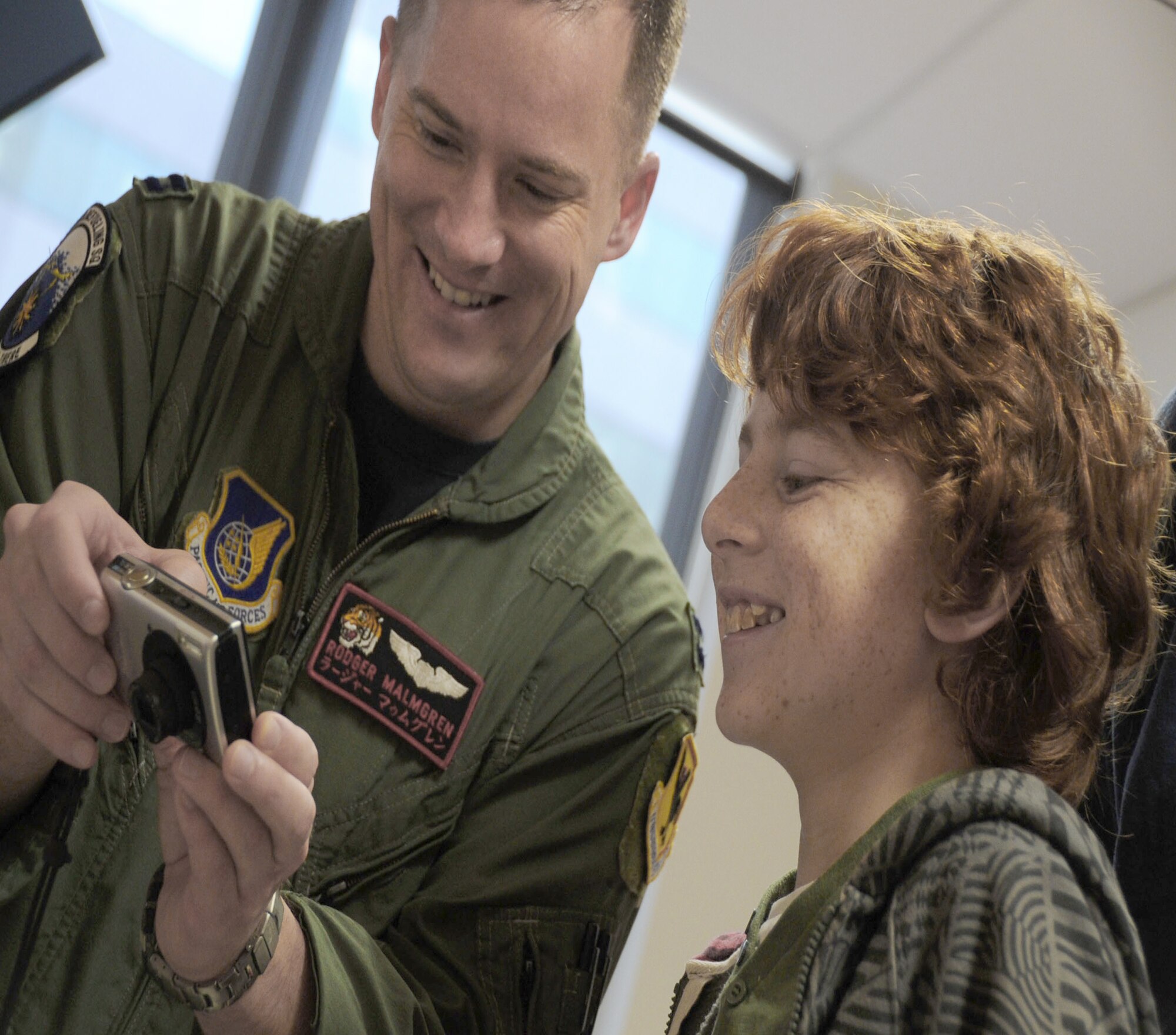 Capt. Rodger Malmgren shows a photo of his aircraft to a patient of the Royal Childrens Hospital here March 1, 2011, in Melbourne, Australia. Captain Malmgren is a KC-135 Stratotanker pilot assigned to the 909th Air Refueling Squadron at Kadena Air Base, Japan. He and four of his aircrew members visited the hospital while participating in the Avalon 2011 Australian International Airshow and Aerospace and Defence Exposition in Geelong, Australia. (U.S. Air Force photo/Master Sgt. Cohen Young)