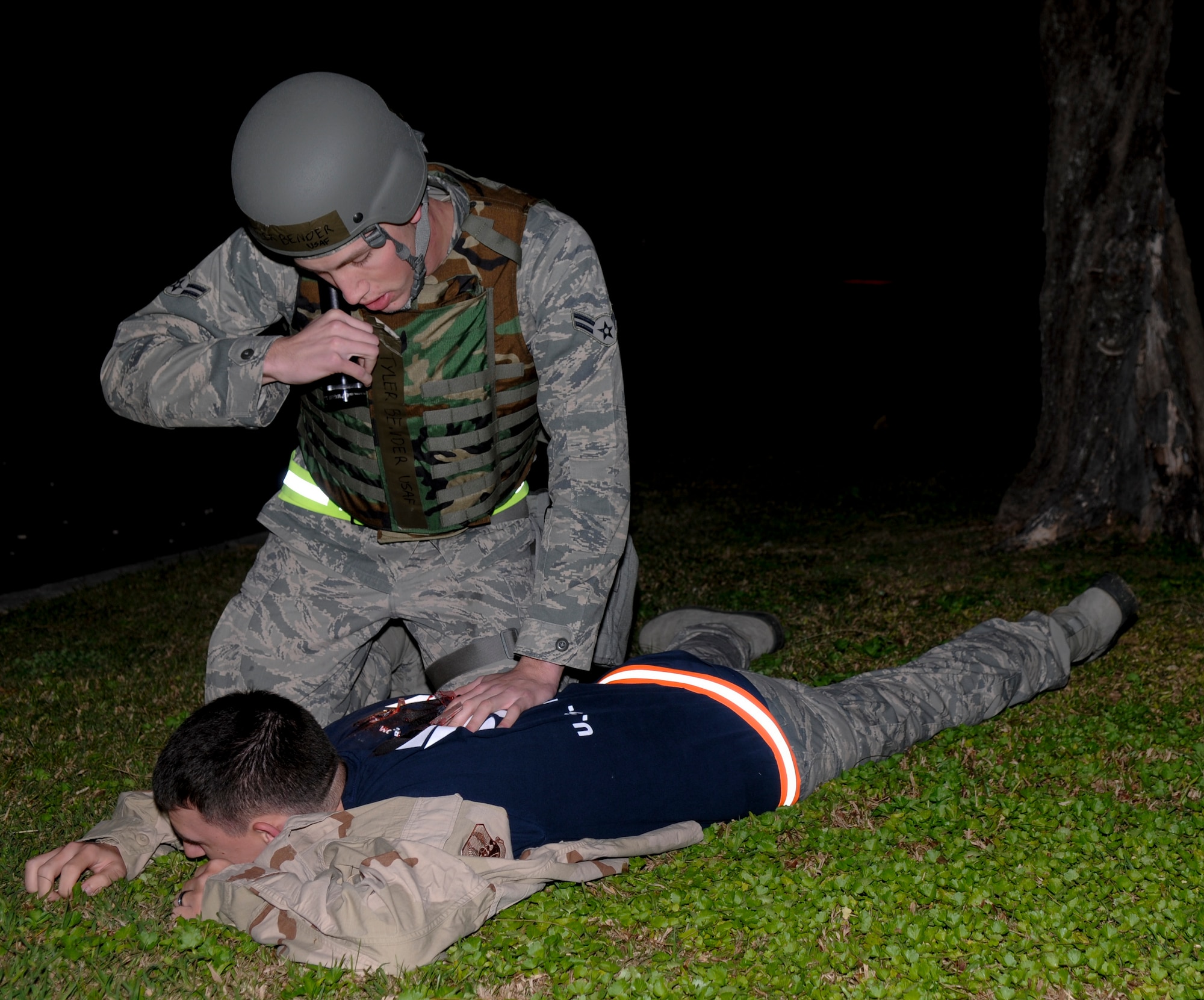 Airman 1st Class Tyler Bender, a member of the 18th Communication Squadron, treats a simulated victim during a training scenario during Beverly High 11-03, a local operational readiness exercise on Kadena Air Base, March 3. The exercise helps prepare Airmen for real world contingencies and keeps their skills sharp. (U.S. Air Force photo/ Airman 1st Class Brooke P. Beers)