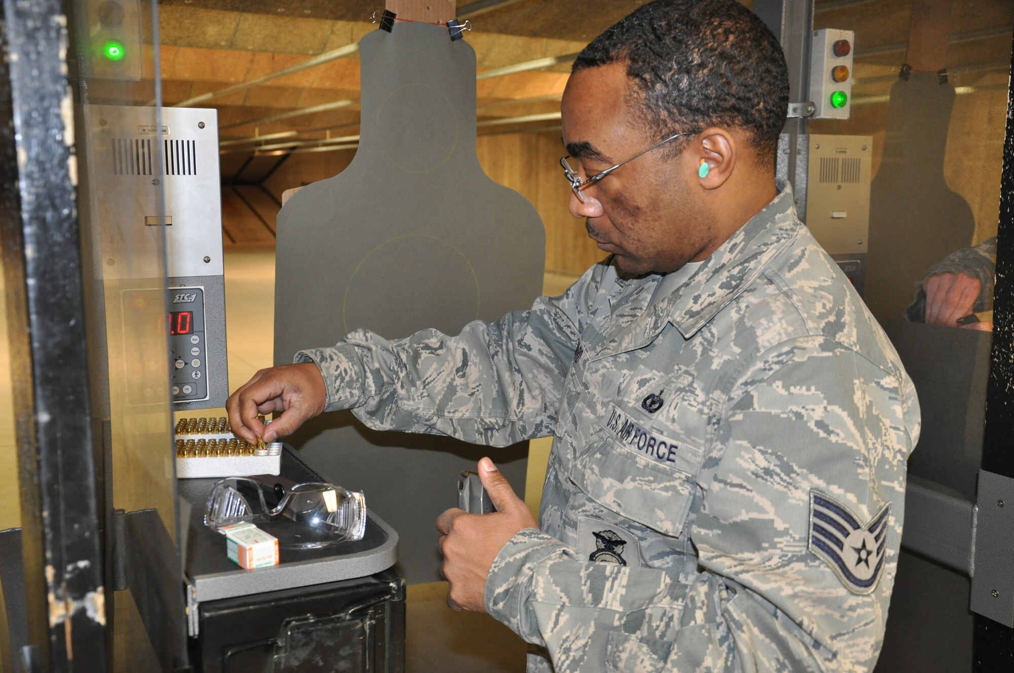 WRIGHT-PATTERSON AIR FORCE BASE, Ohio - Staff Sgt. Ryan Ward, 445th Security Forces Squadron, loads a clip for 9 mm pistol qualification during the Feb. 6 unit training assembly.  This training is an annual requirement for security forces. (U.S. Air Force photo/Tech. Sgt. Jeremy Caskey)