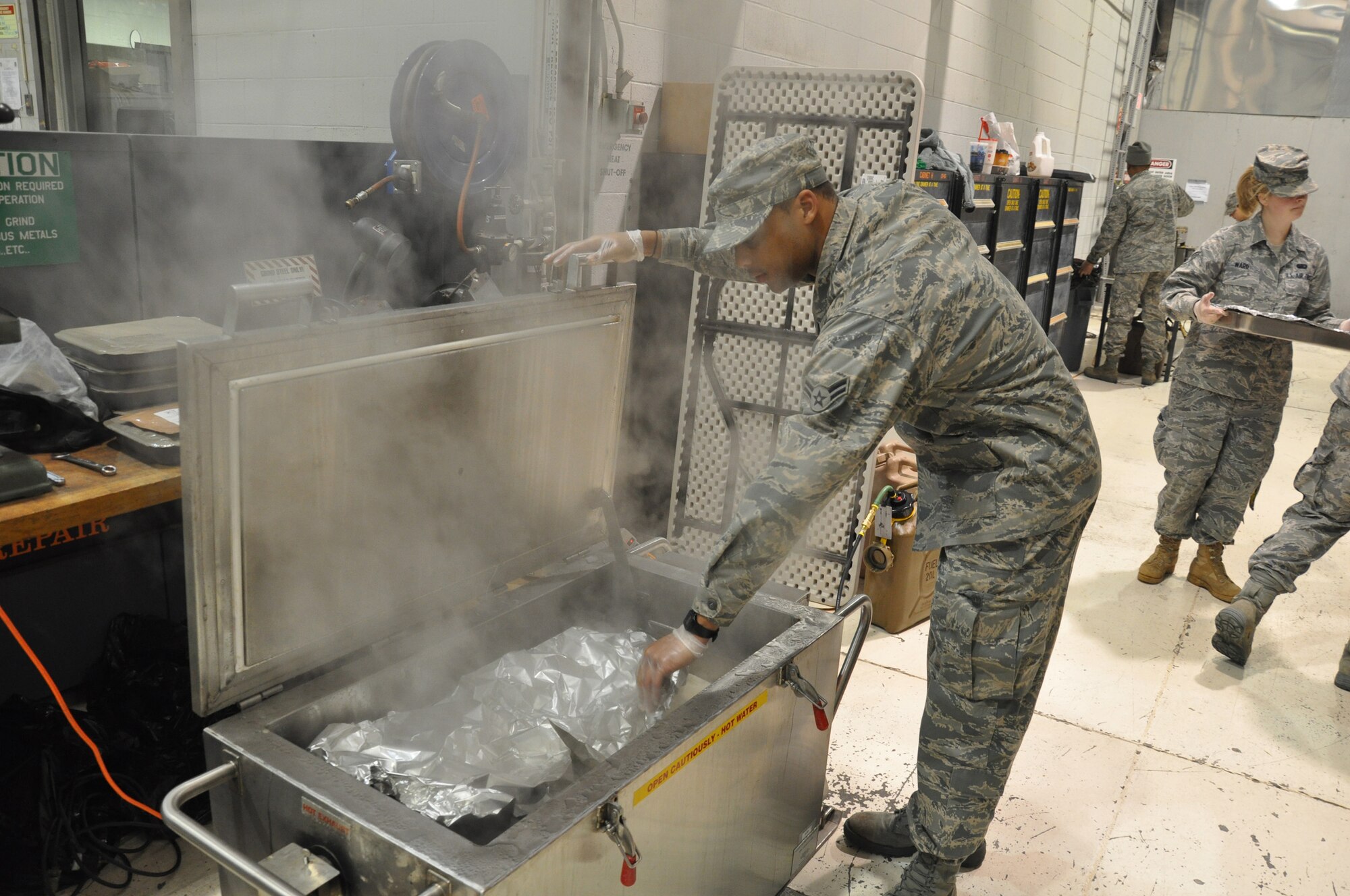 WRIGHT-PATTERSON AIR FORCE BASE, Ohio - Airman 1st Class Gerald Woodard, 445th Services Squadron, warms tortillas for breakfast burritos during the Feb. 6 unit training assembly. (U.S. Air Force photo/Tech. Sgt. Jeremy Caskey)