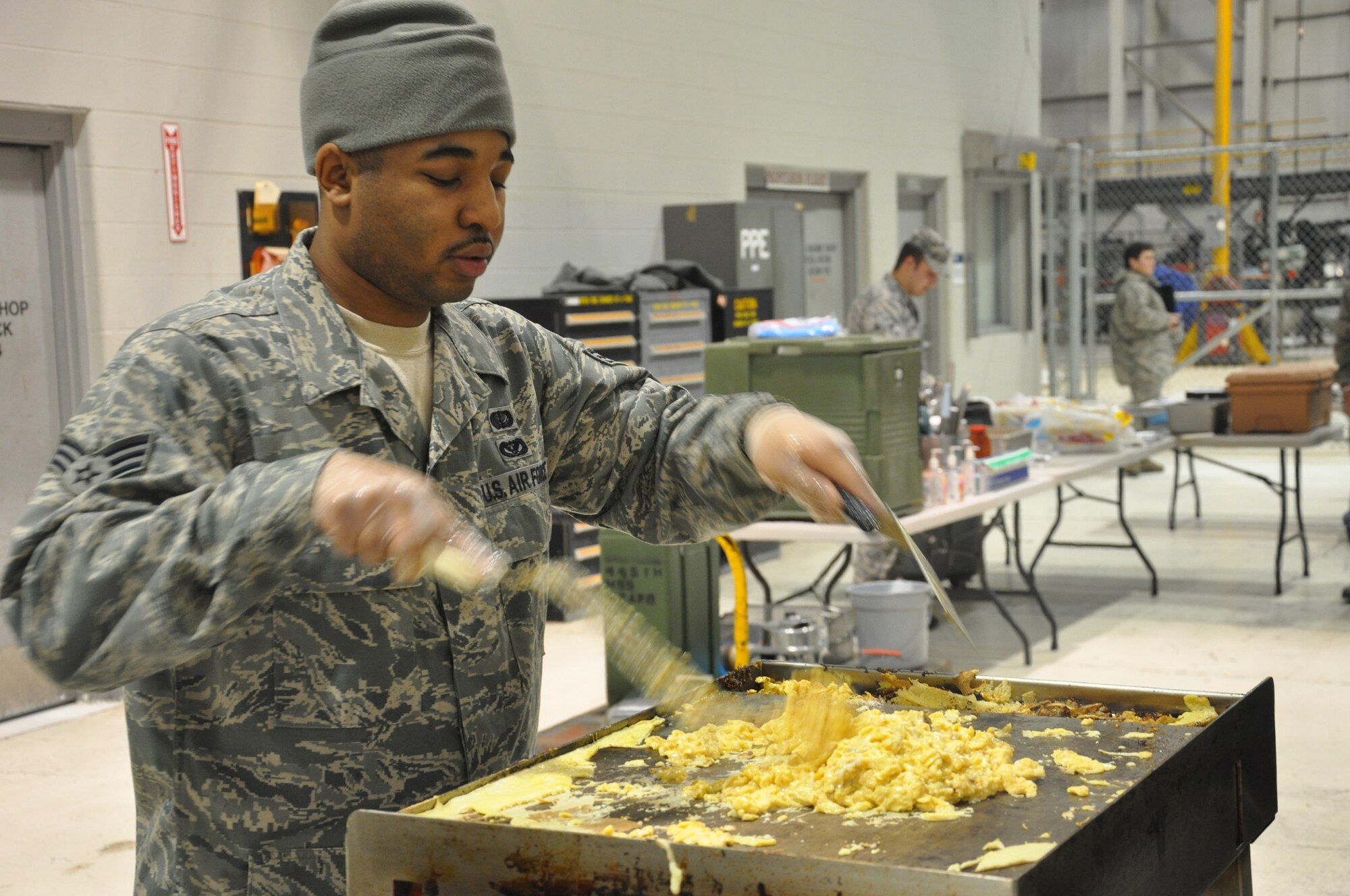 WRIGHT-PATTERSON AIR FORCE BASE, Ohio - Senior Airman Cordell Washington, 445th Services Squadron, prepares eggs for breakfast burritos during the Feb. 6 unit training assembly. (U.S. Air Force photo/Tech. Sgt. Jeremy Caskey)
