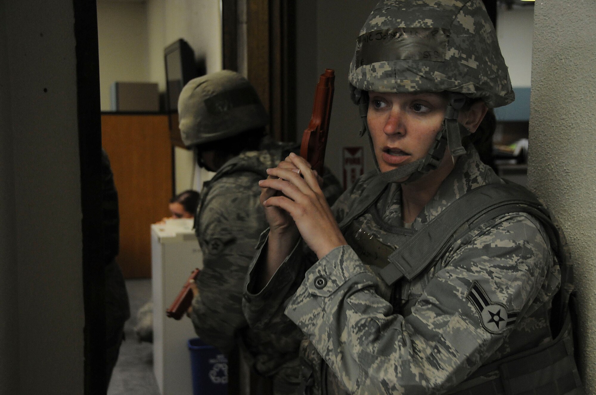 Airman 1st Class Lori Johnson, 18th Security Forces Squadron response force member, provides security as other SFS members search the building during the local operational readiness exercise, Beverly High 11-03 on Kadena Air Base, Japan, March 3. This scenario tested the squadron’s ability to stop the shooter and ensure that every room is secured. (U.S. Air Force photo/ Staff Sgt. Darnell T. Cannady)